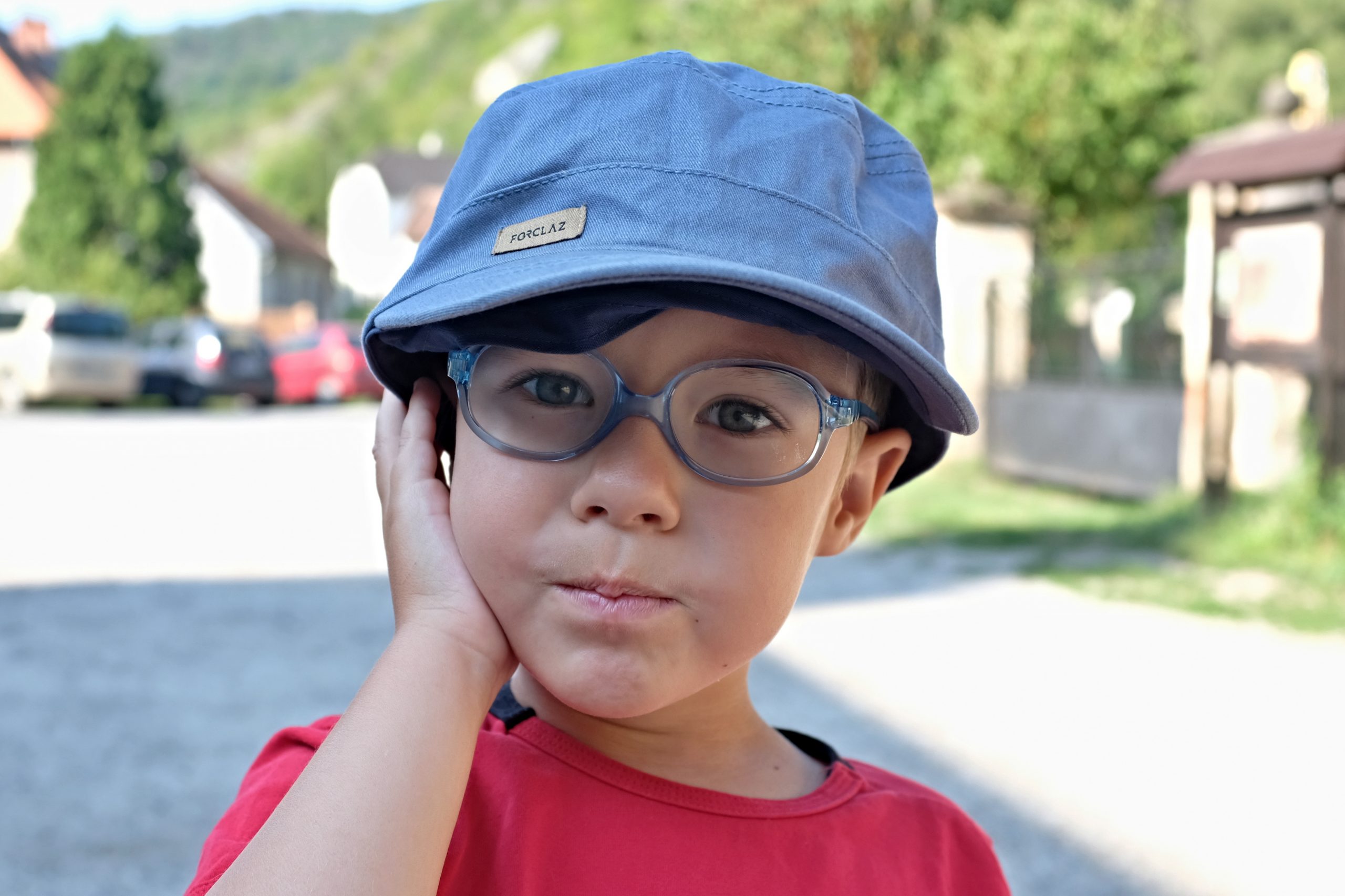 boy in glasses wearing a sunhat