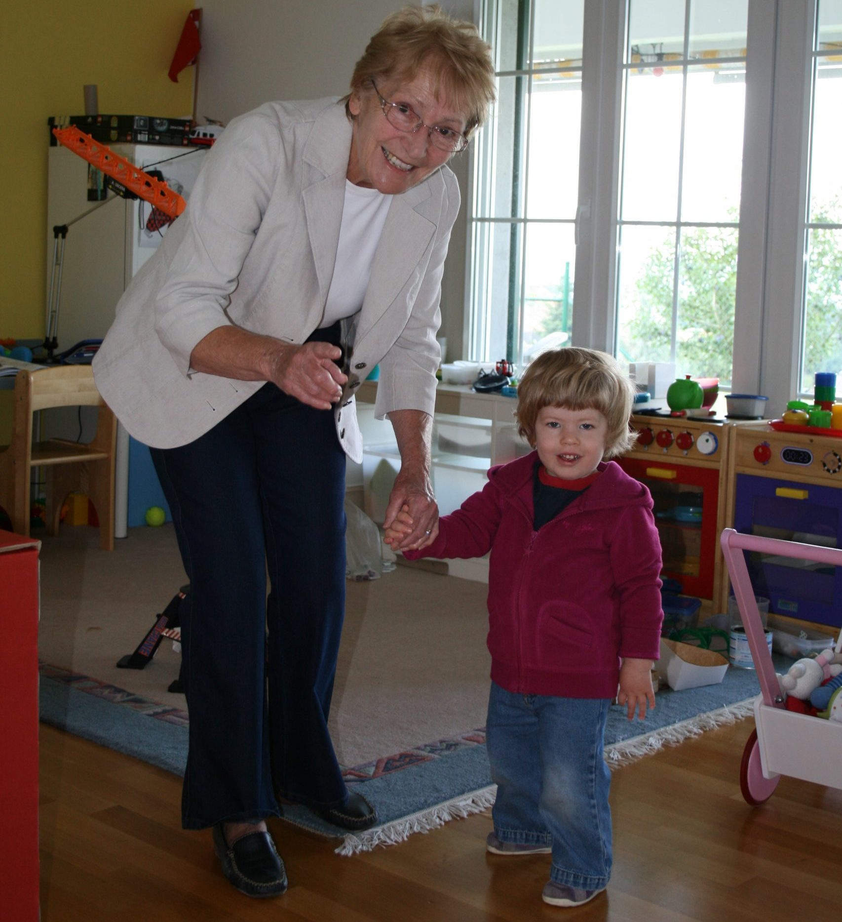 Grandma and grand daughter holding hands