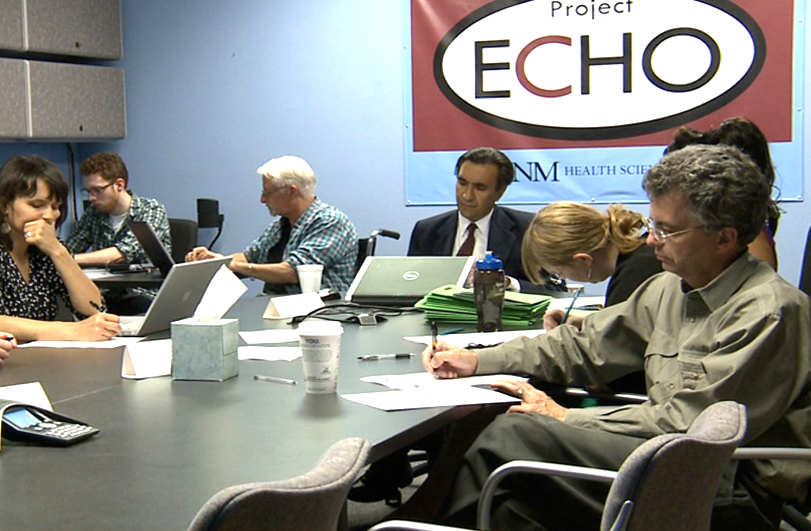 group of professional sat around a board room table