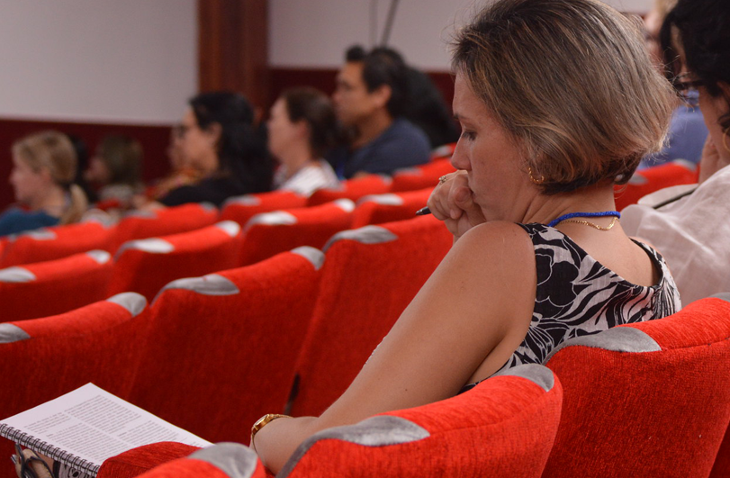 lady on red cinema seating reading a report