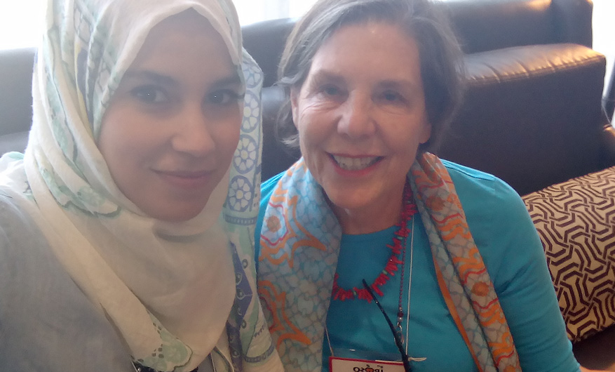 two females, one in a headscarf looking at the camera