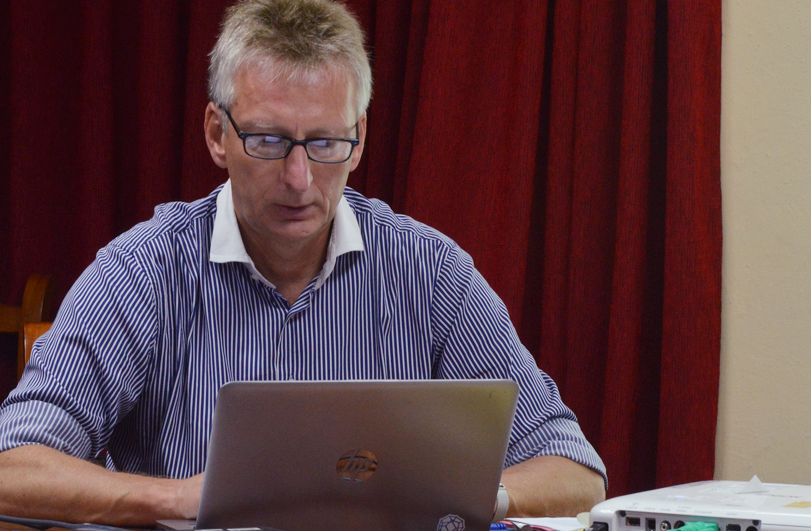 man in blue shirt at a laptop
