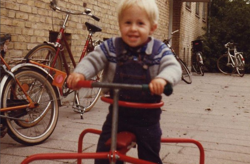 toddler on red tricycle