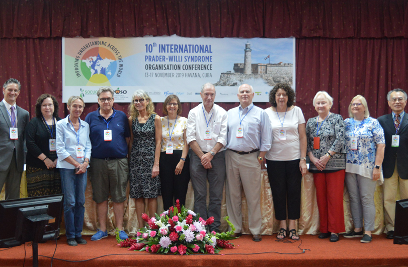 large group of people stood on a red stage