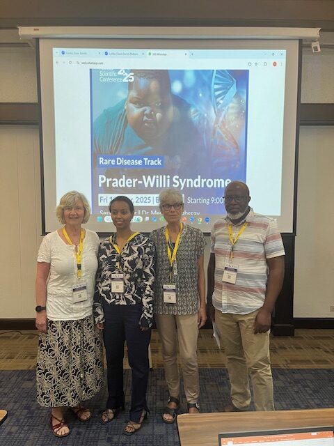 Group in front of Rare Disease screen People standing at exhibition